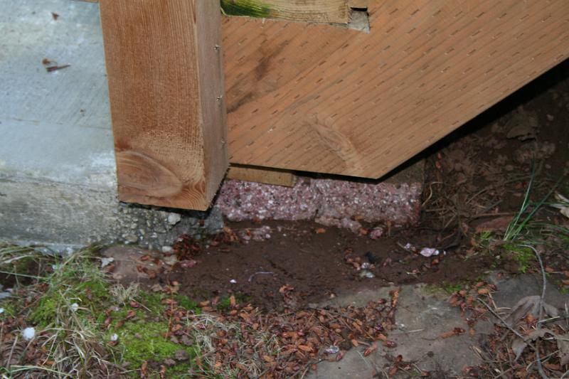 IMG_1740.JPG - Stair posts only sitting on pavers with a shim. Nothing to keep it secure